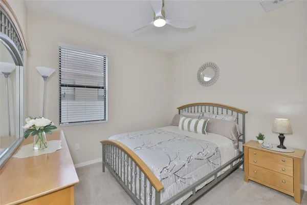 a bedroom with a bed and a book shelf