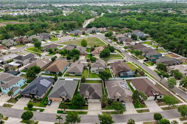 a view of a yard with wooden fence