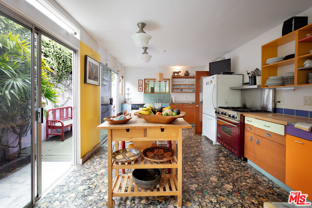 805 Hampton Drive Venice, CA 90291 - Photo 15 of 27 a kitchen with stainless steel appliances granite countertop a refrigerator a stove and a dining table with wooden floor
