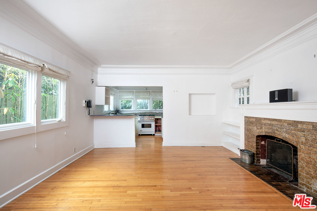 805 Hampton Drive Venice, CA 90291 - Photo 23 of 27 a view of empty room with wooden floor and fireplace