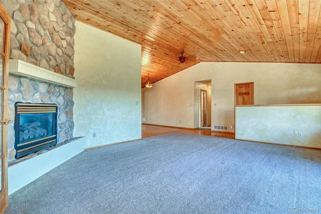 a view of an empty room with a fireplace