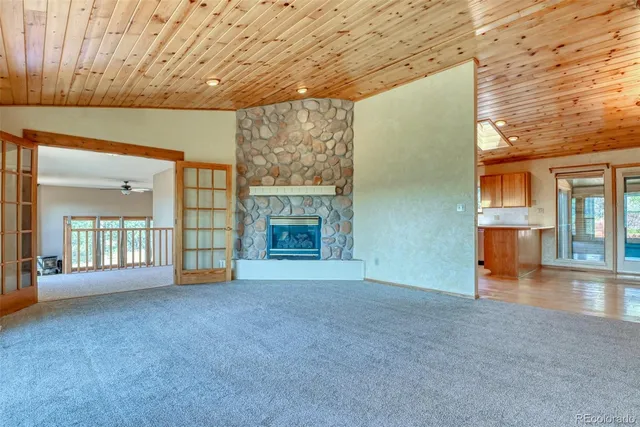 a view of an empty room with a fireplace