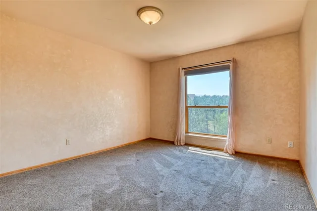 an empty room with a empty space and a window