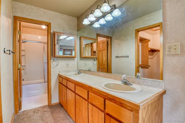 a bathroom with a sink double vanity and a mirror