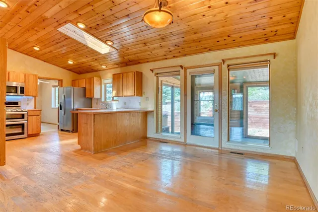 a view of kitchen with furniture and wooden floor