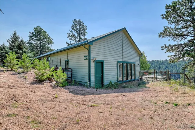 a house with a large tree in the background