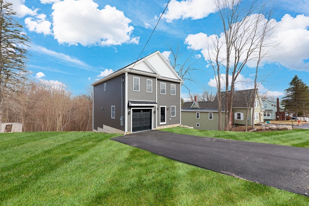 673 Pleasant Street Leicester, MA 01542 - Photo 1 of 38 a house view with a garden space