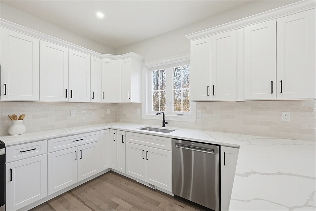 673 Pleasant Street Leicester, MA 01542 - Photo 14 of 38 a kitchen with white cabinets sink and dishwasher