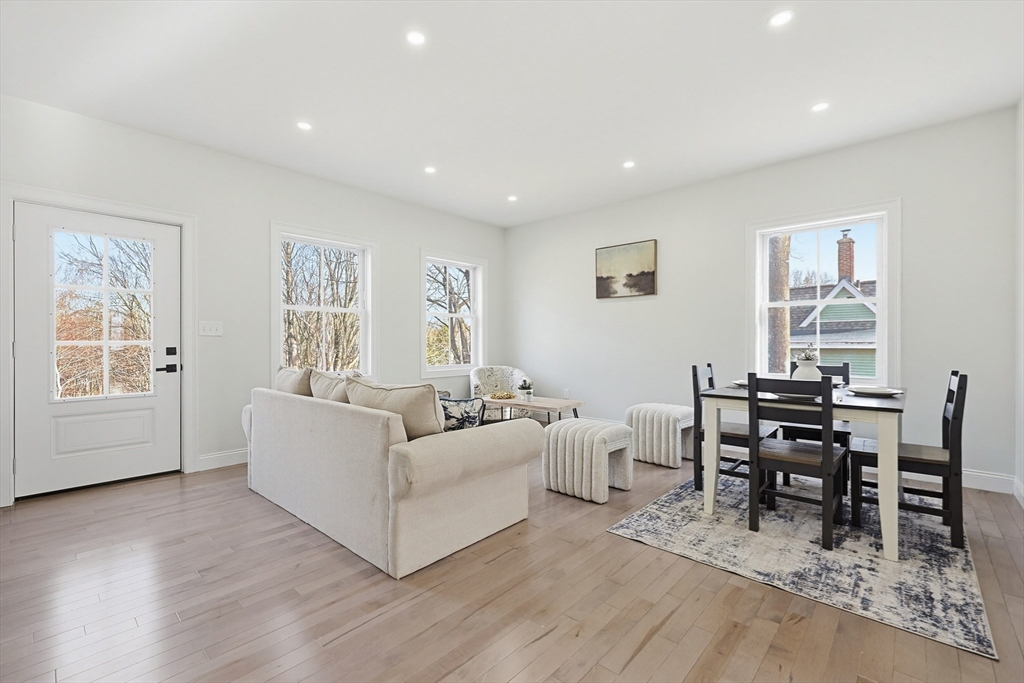 673 Pleasant Street Leicester, MA 01542 - Photo 15 of 38 a living room with furniture a dining table and a window