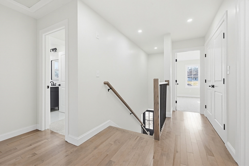 673 Pleasant Street Leicester, MA 01542 - Photo 19 of 38 a view of a hallway with wooden floor and staircase
