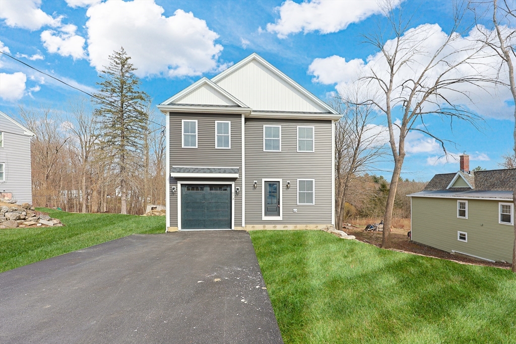 673 Pleasant Street Leicester, MA 01542 - Photo 2 of 38 a front view of a house with a garden and yard