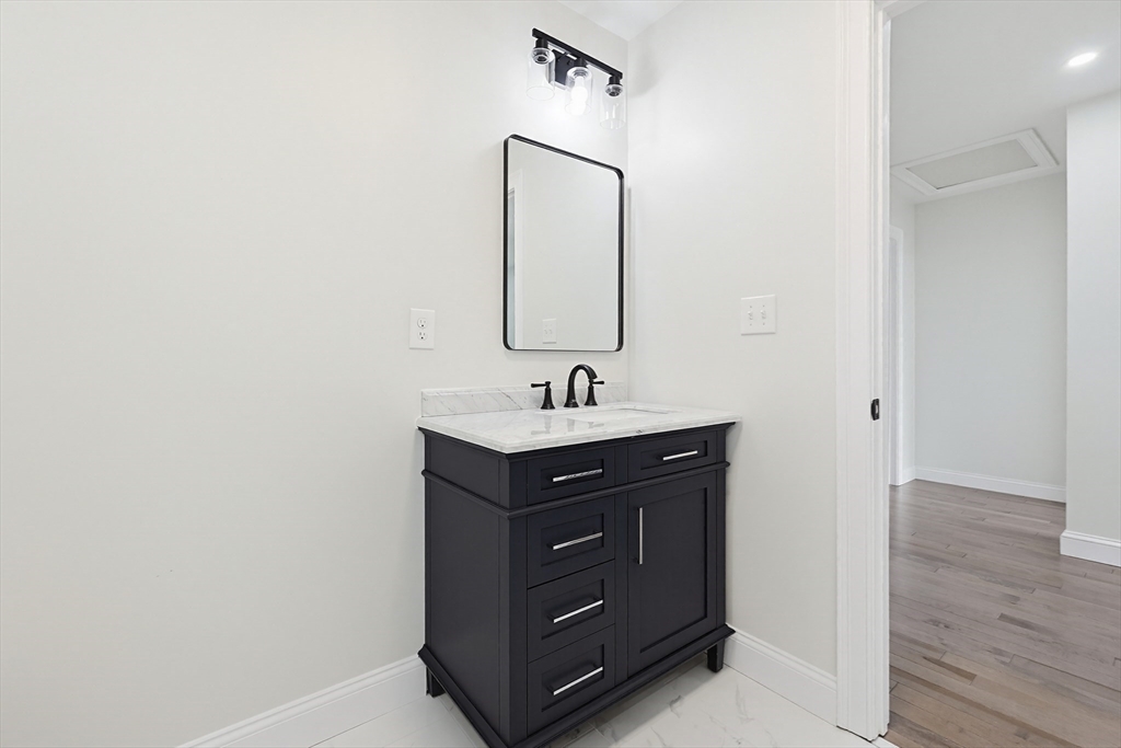 673 Pleasant Street Leicester, MA 01542 - Photo 23 of 38 a bathroom with a sink and a mirror