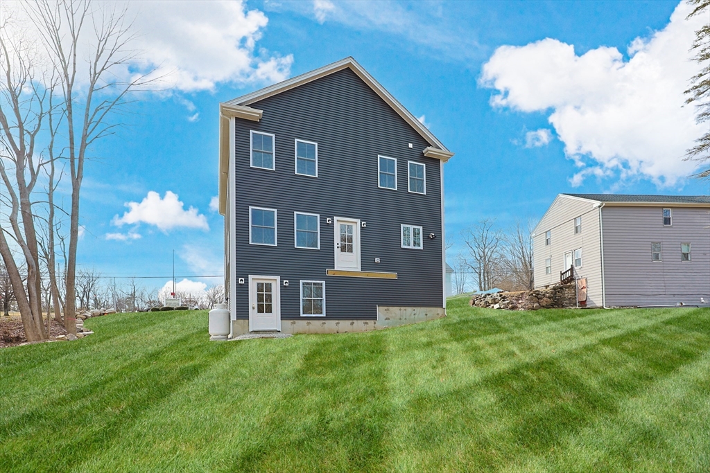 673 Pleasant Street Leicester, MA 01542 - Photo 4 of 38 a front view of house with yard and trees in the background