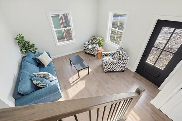 a living room with furniture and wooden floor