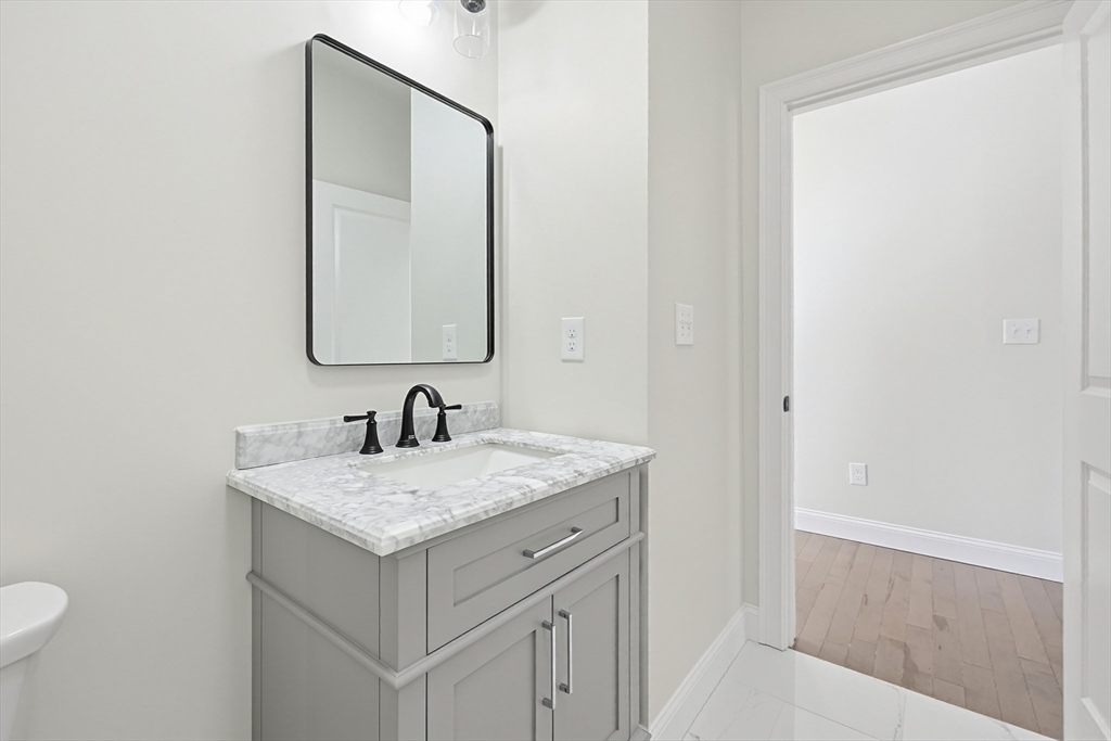 673 Pleasant Street Leicester, MA 01542 - Photo 9 of 38 a bathroom with a granite countertop sink and a mirror