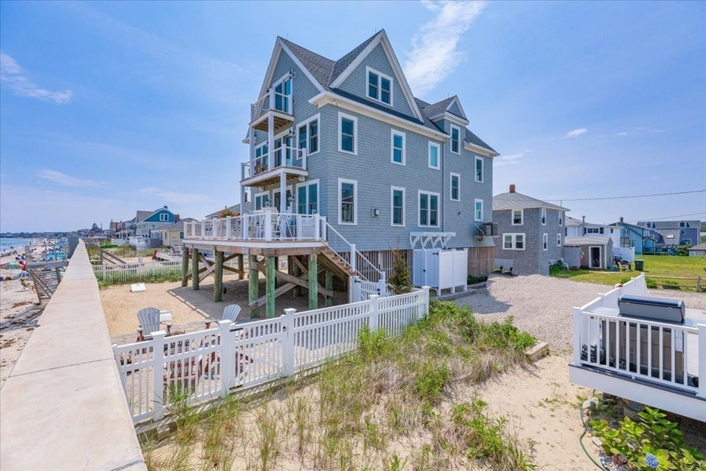 a view of roof deck with barbeque grill and wooden floor