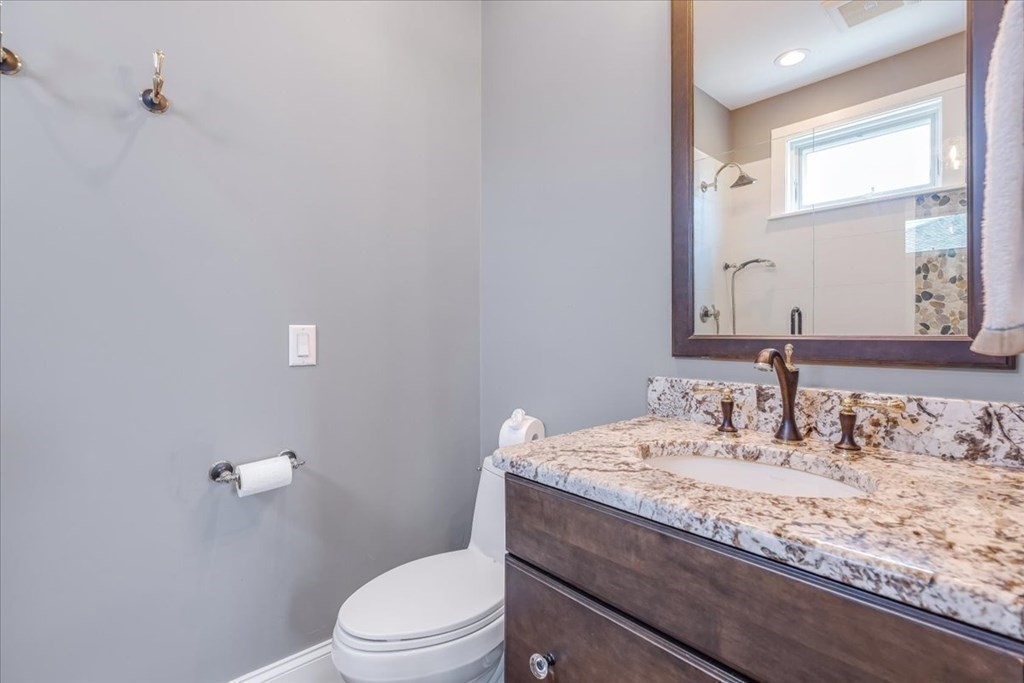 12 Monitor Road Marshfield, MA 02050 - Photo 17 of 42 a bathroom with a granite countertop sink a toilet and a mirror