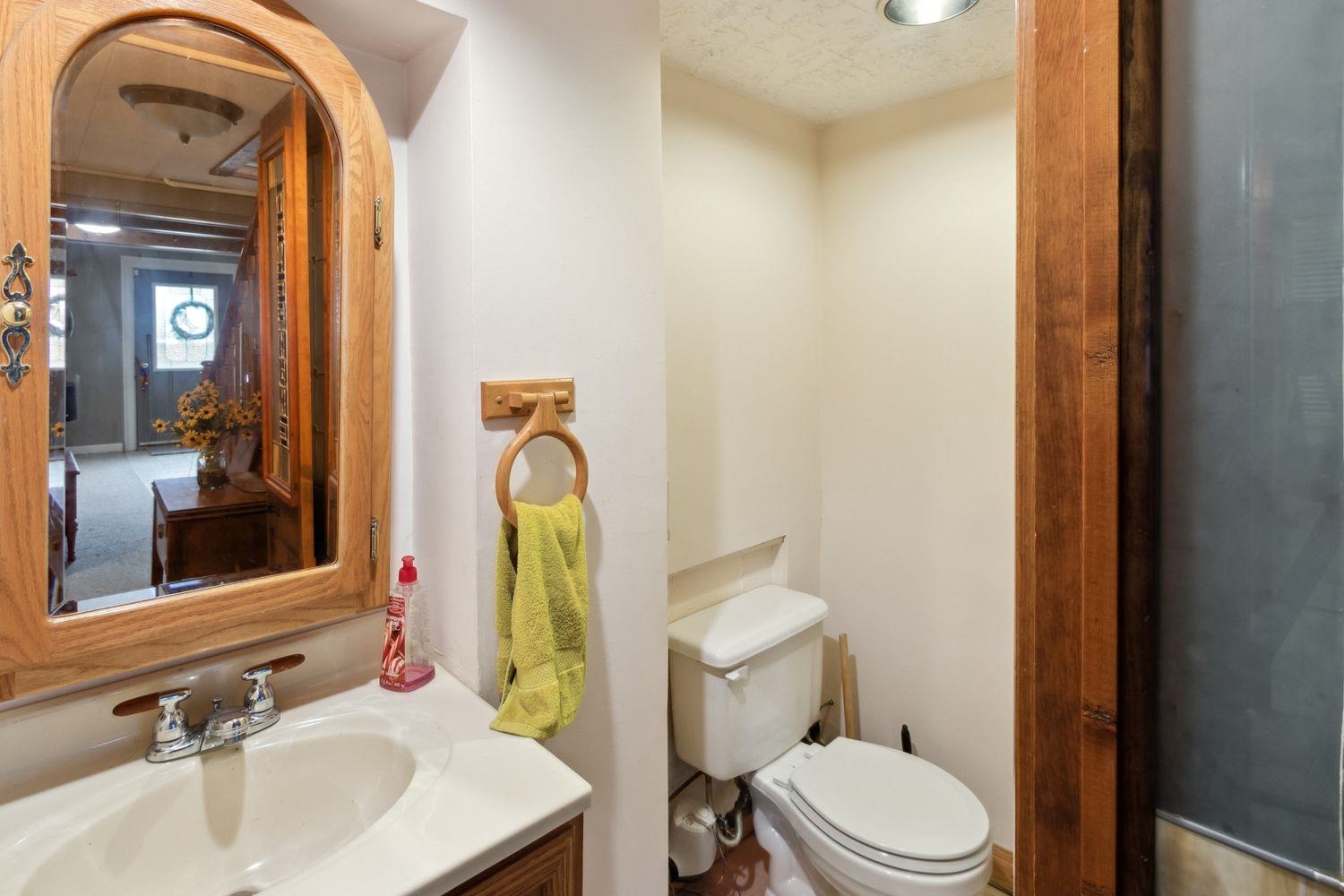 1205 Robin Road Dixon, IL 61021 - Photo 23 of 29 a bathroom with a toilet a sink and a mirror