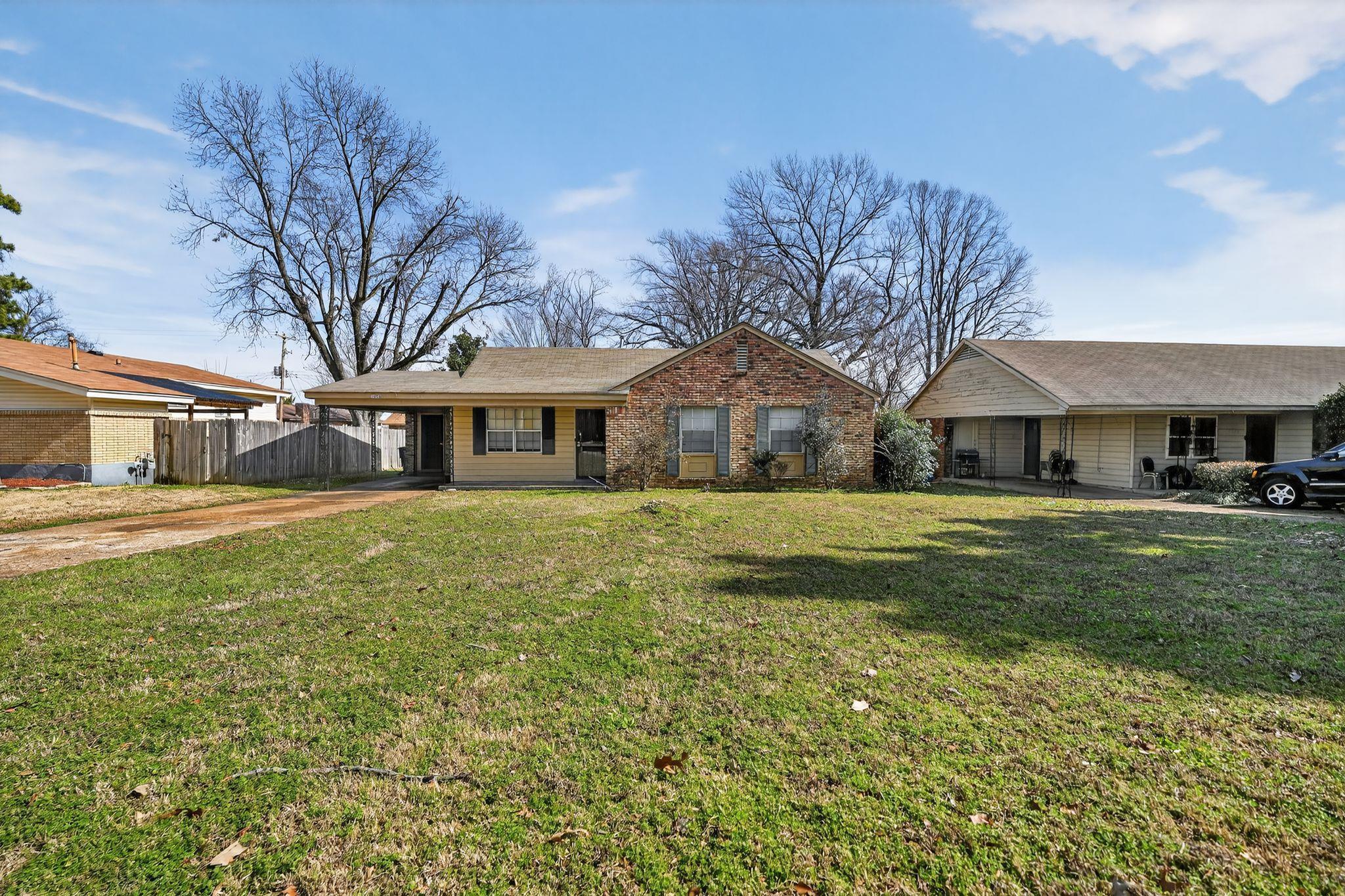 3470 Neely Road Memphis, TN 38109 - Photo 1 of 34 a front view of a house with a garden