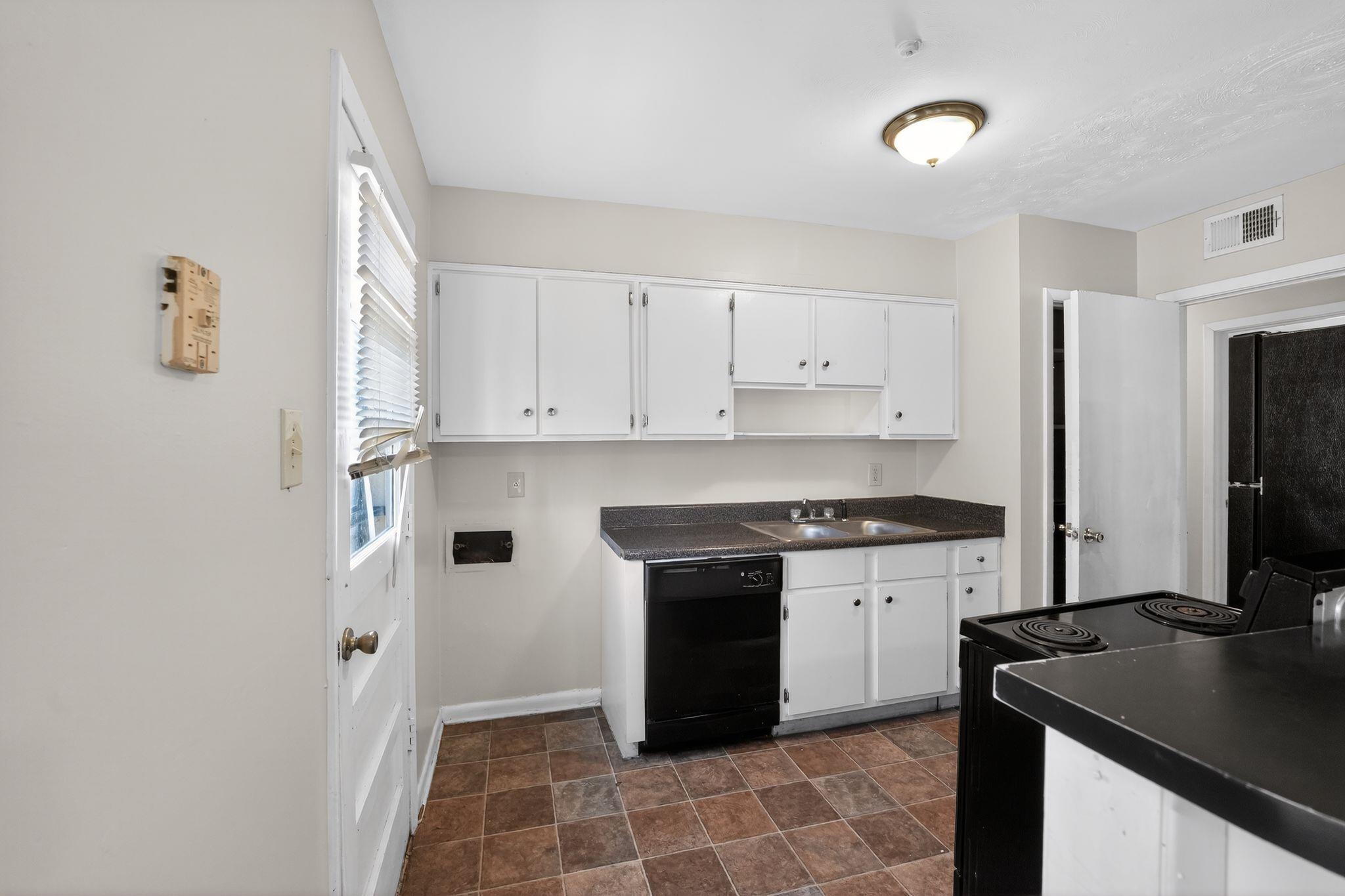 3470 Neely Road Memphis, TN 38109 - Photo 21 of 34 a kitchen with stainless steel appliances granite countertop a stove a refrigerator and a sink