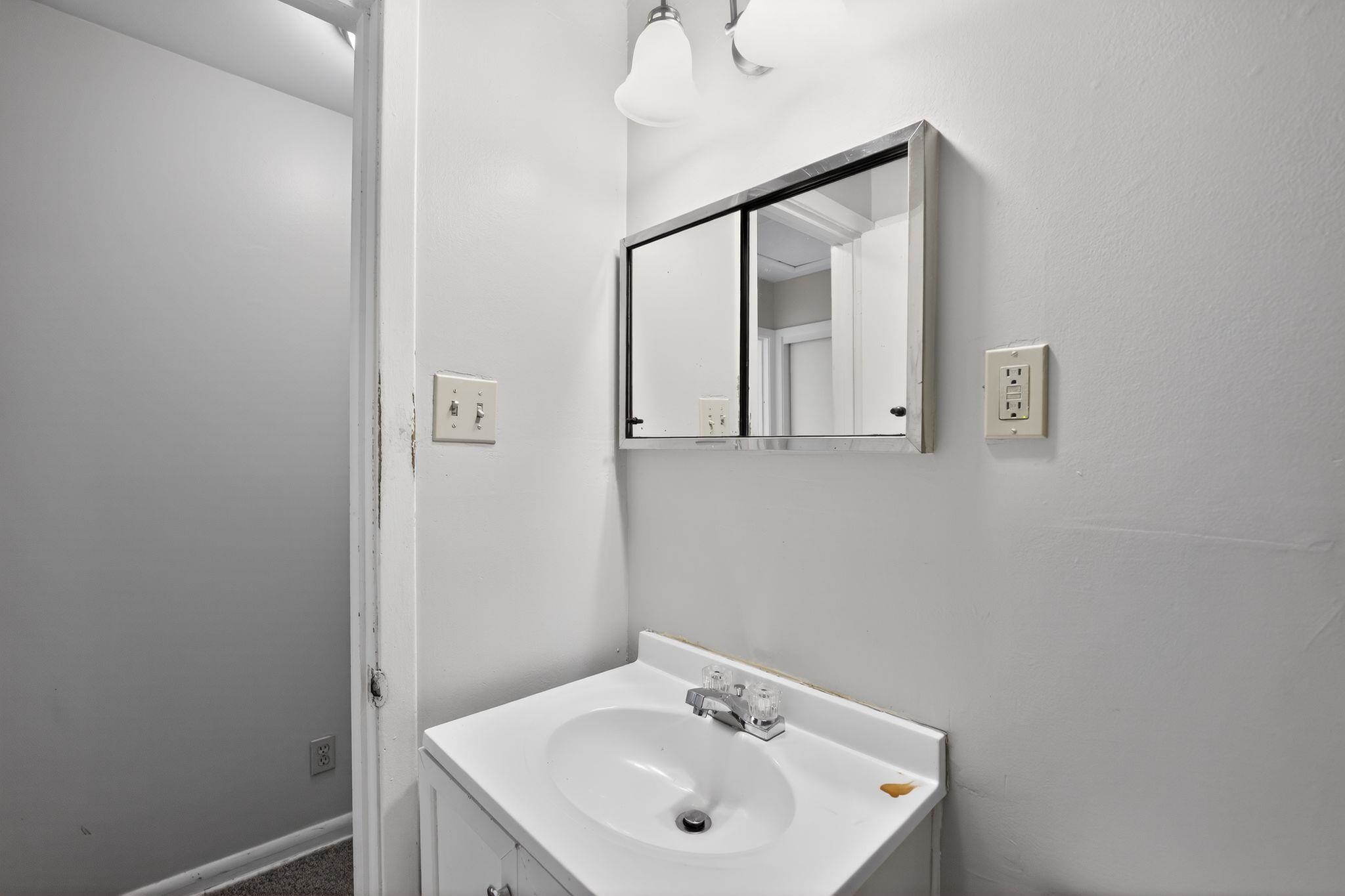 3470 Neely Road Memphis, TN 38109 - Photo 30 of 34 a bathroom with a sink a mirror and shower