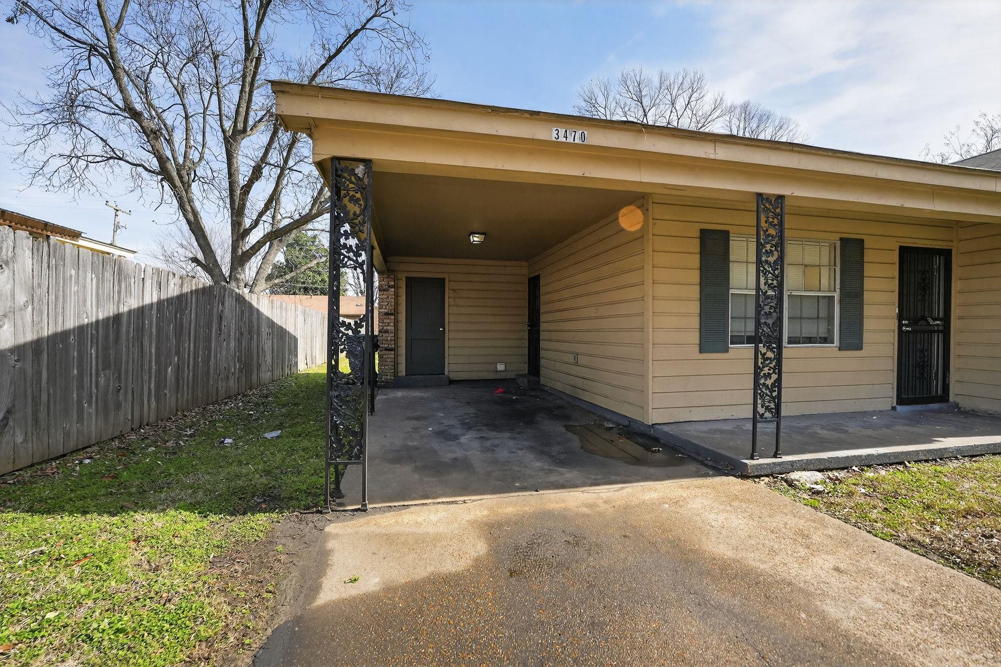 3470 Neely Road Memphis, TN 38109 - Photo 3 of 34 a view of a house with a small yard and wooden fence