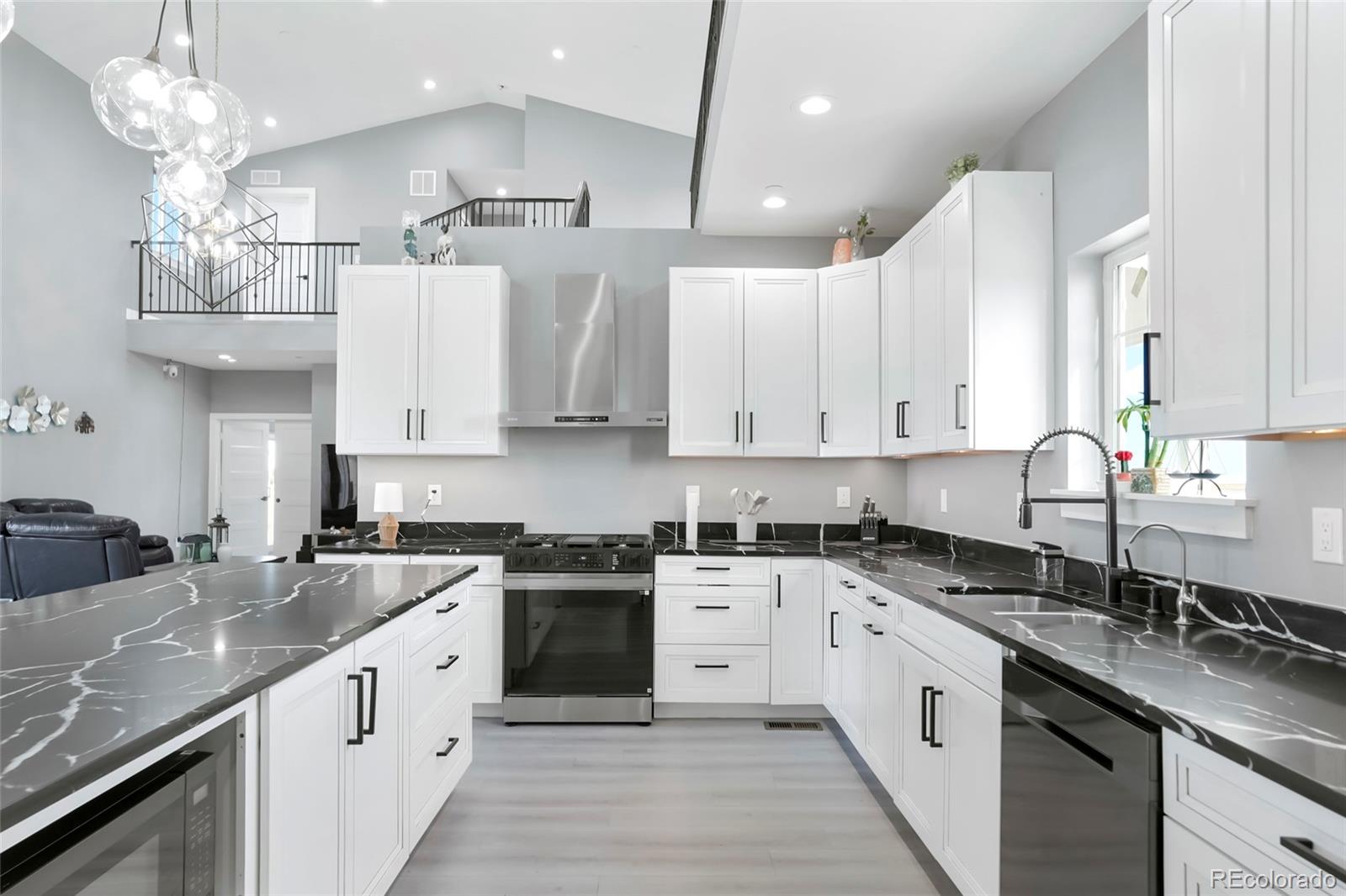3161 Xmore Road Byers, CO 80103 - Photo 11 of 46 a kitchen with a sink stove and cabinets
