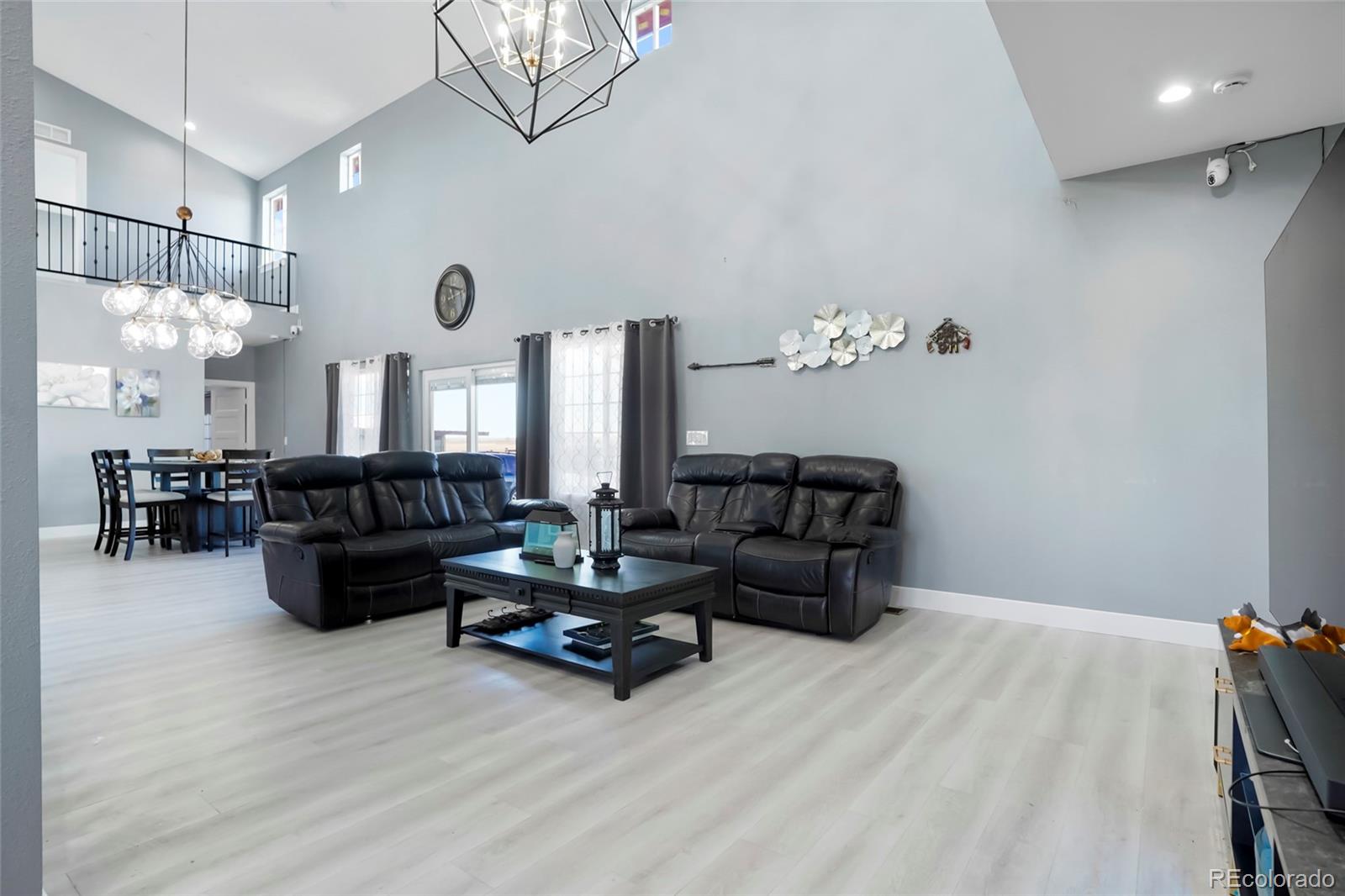 3161 Xmore Road Byers, CO 80103 - Photo 13 of 46 a living room with furniture and wooden floor