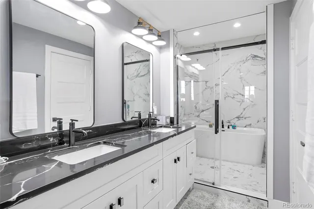 a bathroom with double vanity sinks and a mirror