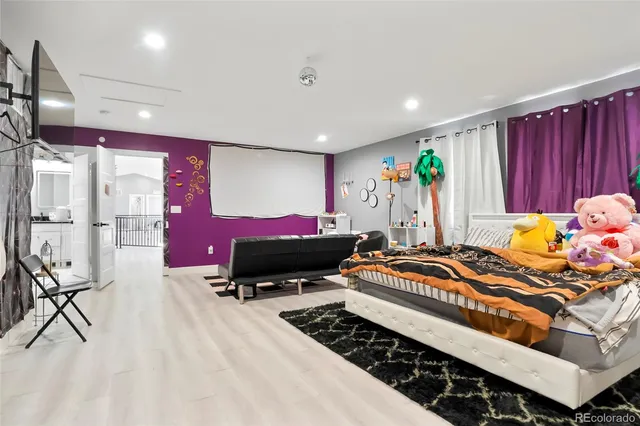 a bedroom with furniture and a flat screen tv