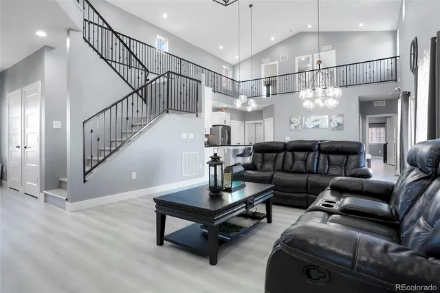 a living room with furniture ceiling fan and a rug
