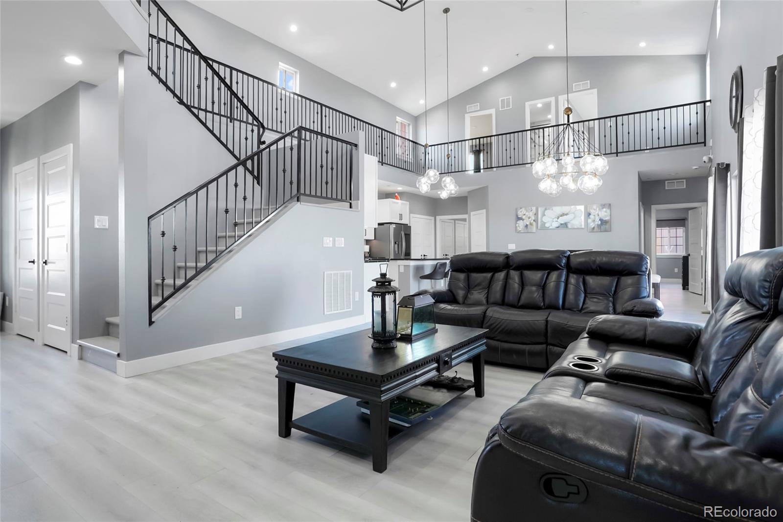 3161 Xmore Road Byers, CO 80103 - Photo 2 of 46 a living room with furniture ceiling fan and a rug