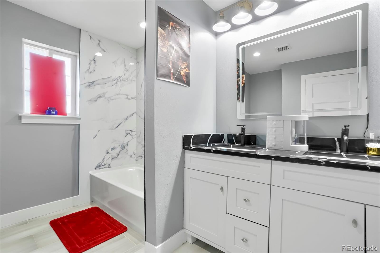 3161 Xmore Road Byers, CO 80103 - Photo 21 of 46 a en suite bathroom with a sink shower and a mirror