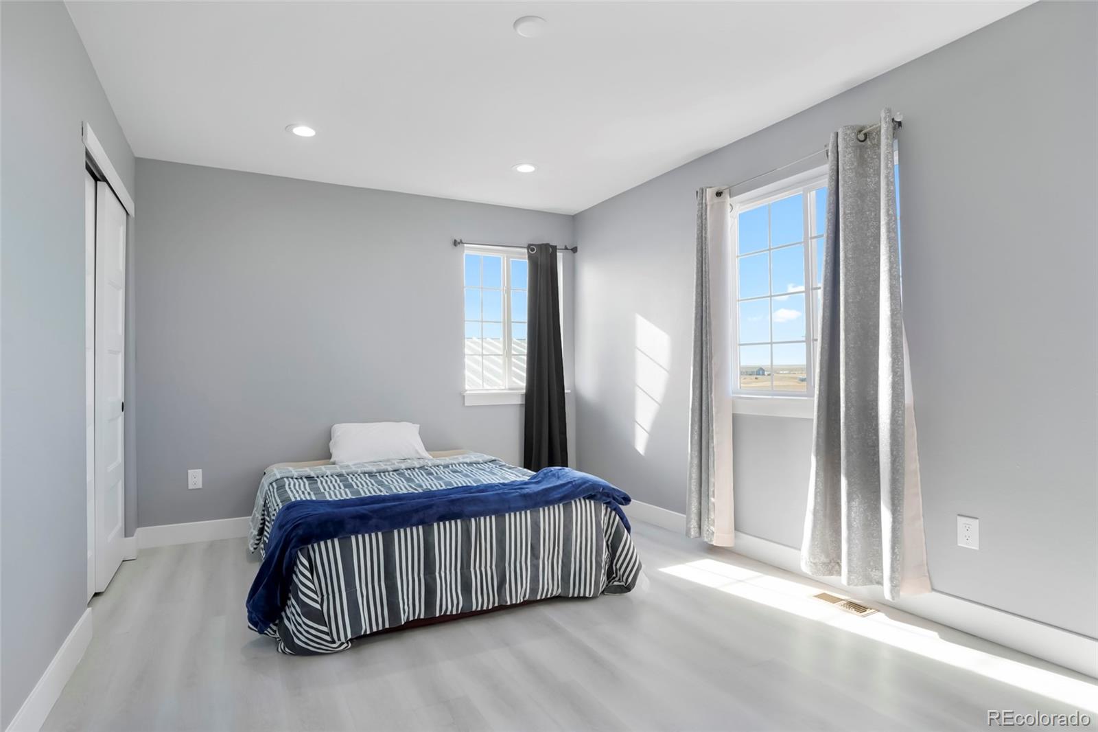 3161 Xmore Road Byers, CO 80103 - Photo 22 of 46 a bedroom with a bed and window