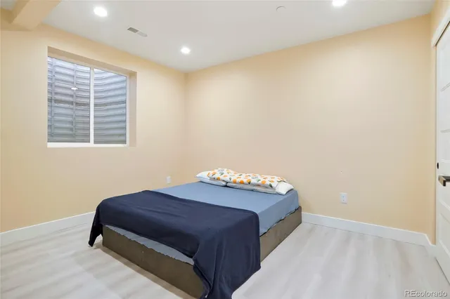 a spacious bedroom with a bed and a window