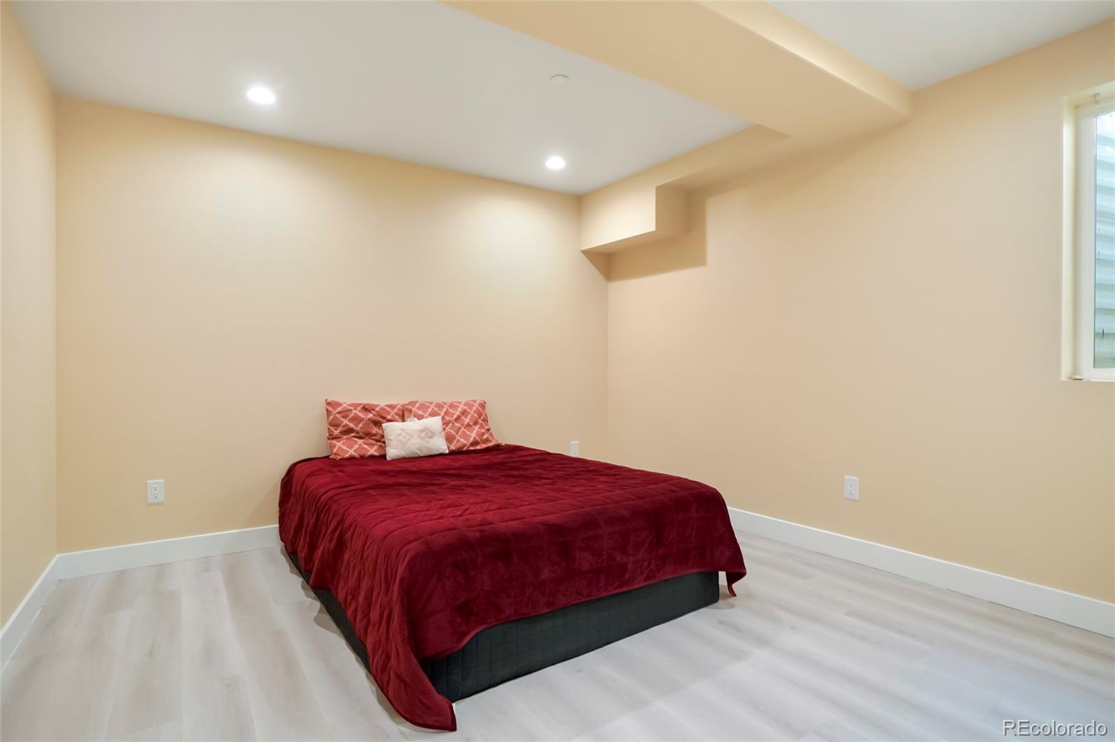 3161 Xmore Road Byers, CO 80103 - Photo 32 of 46 a bedroom with a bed and a night stand