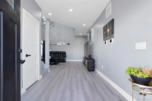 a kitchen with furniture and a potted plant