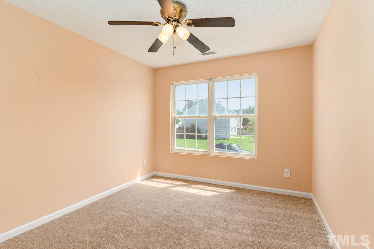 2904 Hayling Drive Raleigh, NC 27610 - Photo 20 of 24 an empty room with a window and a fan