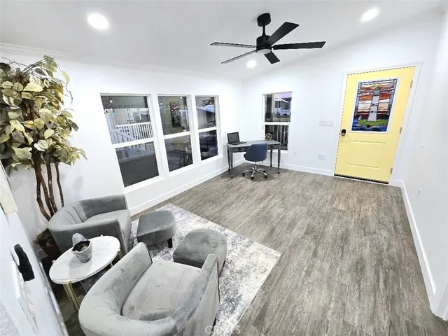 a living room with furniture windows and a table