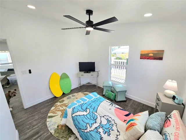 a bedroom with a bed and flat screen tv