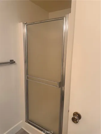 a bathroom with a glass shower door
