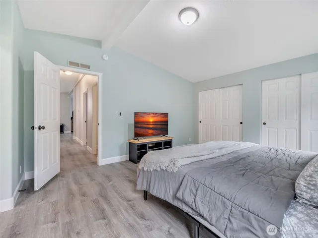 a bedroom with a bed and a television