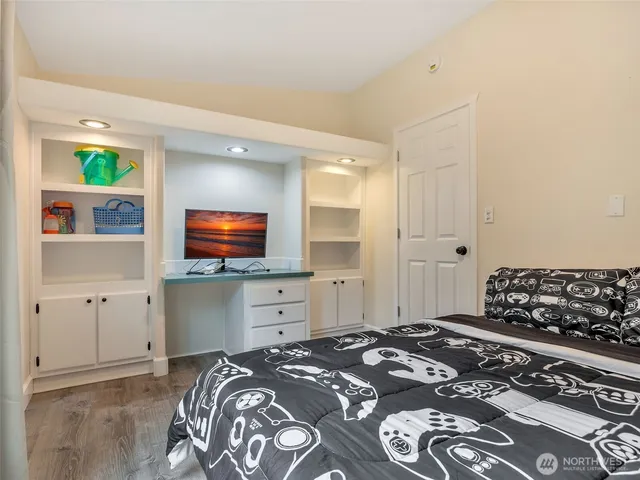 a bedroom with a bed and a flat screen tv