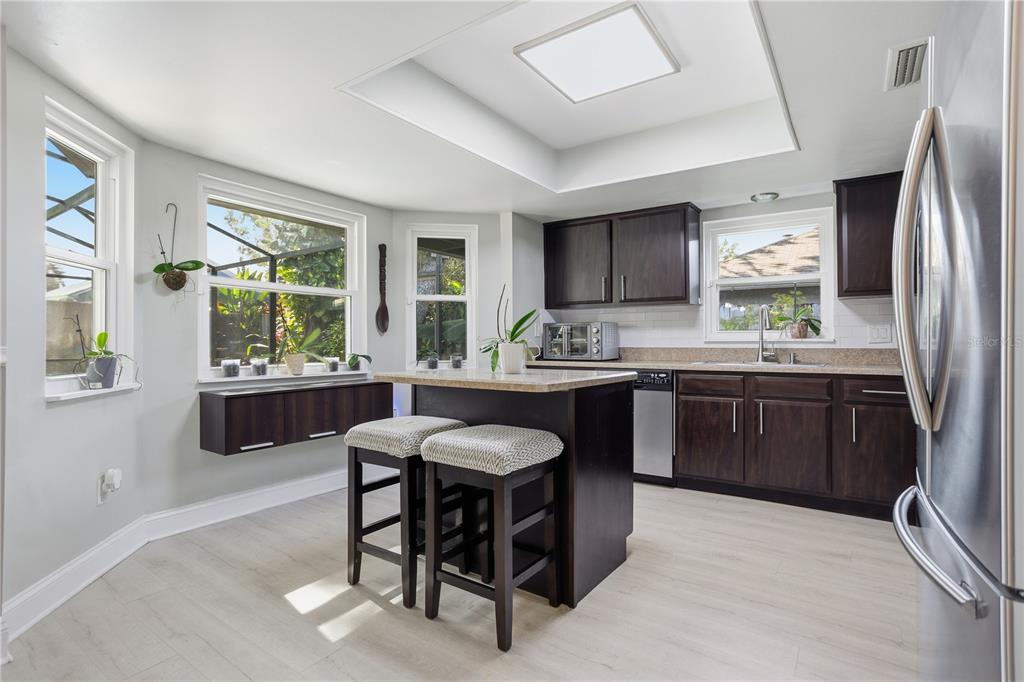 7550 Herricks Loop Orlando, FL 32835 - Photo 13 of 37 a kitchen with stainless steel appliances granite countertop a stove a sink a refrigerator and a microwave