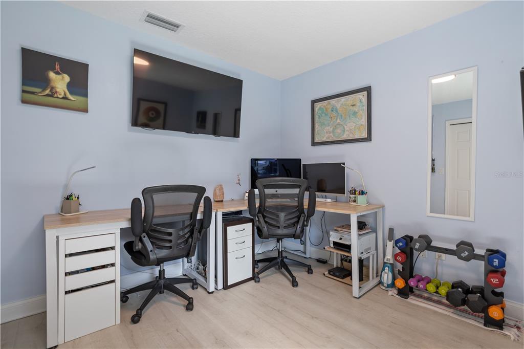 7550 Herricks Loop Orlando, FL 32835 - Photo 20 of 37 a view of a workspace with furniture and a flat screen tv