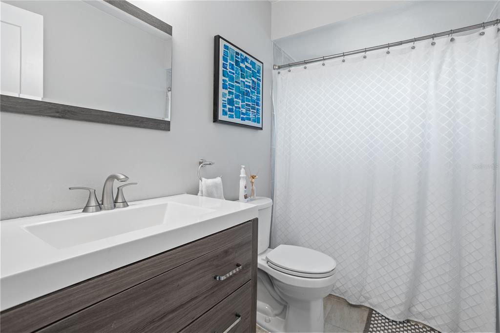 7550 Herricks Loop Orlando, FL 32835 - Photo 21 of 37 a bathroom with a sink a toilet and a mirror
