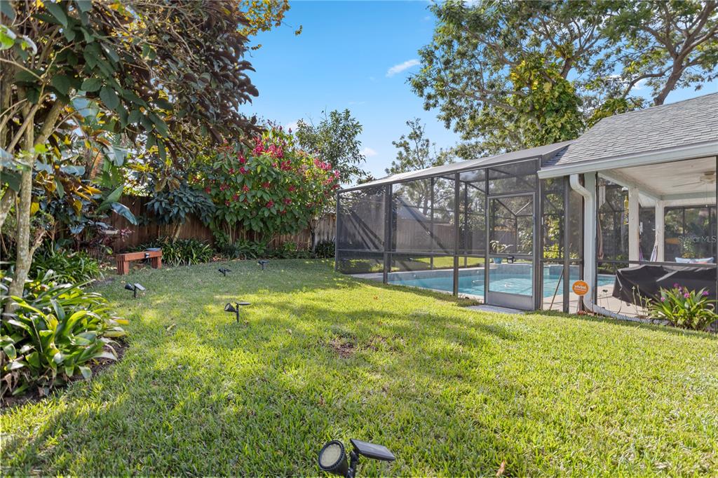 7550 Herricks Loop Orlando, FL 32835 - Photo 37 of 37 a view of backyard with table and chairs and wooden fence