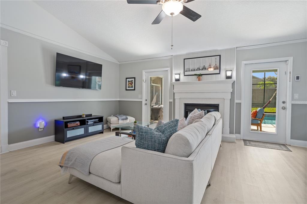 7550 Herricks Loop Orlando, FL 32835 - Photo 7 of 37 a living room with furniture and a fireplace