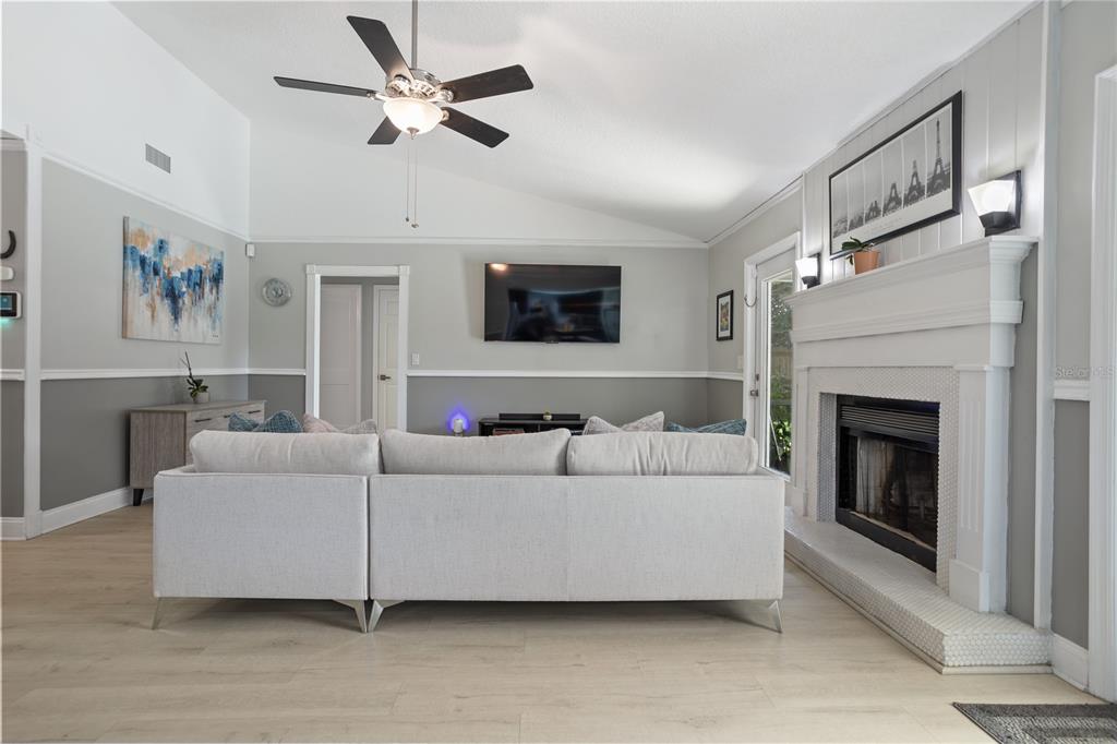 7550 Herricks Loop Orlando, FL 32835 - Photo 9 of 37 a living room with furniture and a fireplace