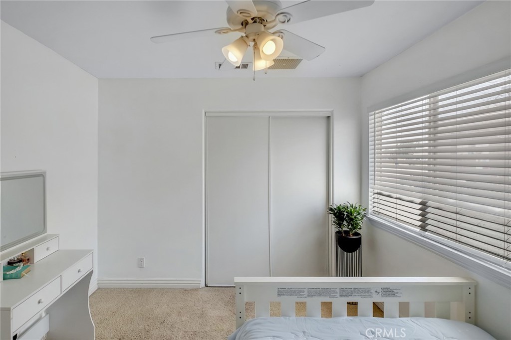 14952 Rivers Edge Road Helendale, CA 92342 - Photo 21 of 33 a bedroom with a bed and a chandelier